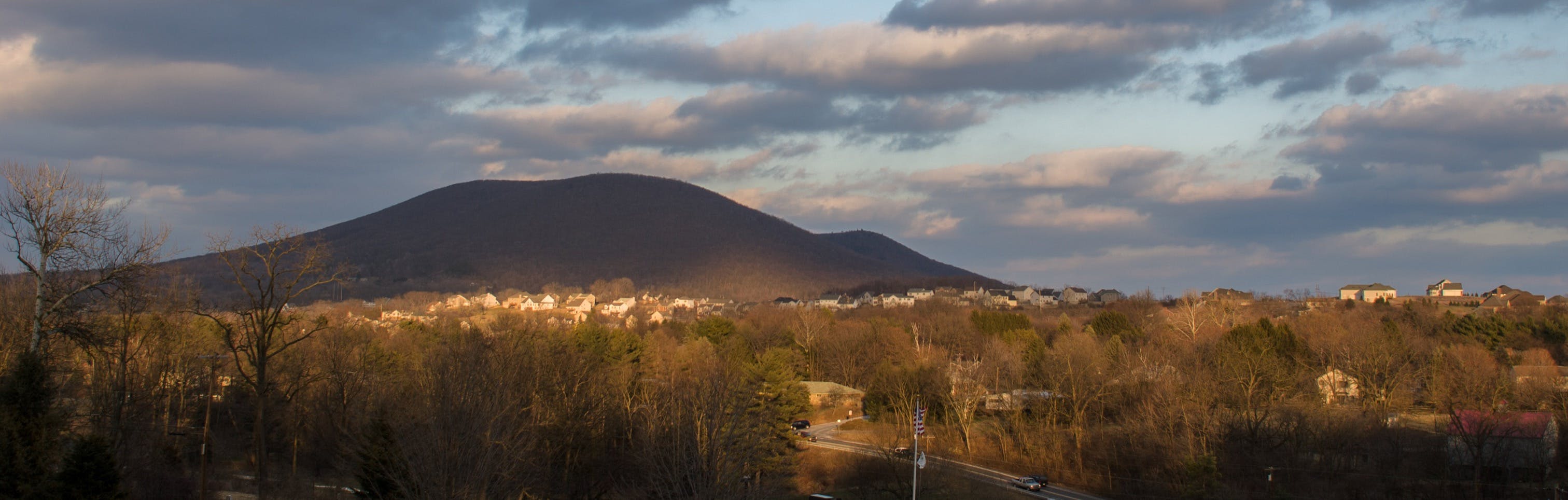 Mount Nittany and skyline of State College houses at sunset